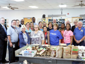 Sigmon and Gulf Atlantic District leaders gather with employees at the Hazlehurst, GA, Post Office. From left are Postmaster Winton Lacey Jr., Ray Harrell, Megan Powell, Marketing Manager Lucious Sumlar, Betty Clark, Helen Adams, Gina Rozier, Roland Reed, Betty Carter, JoAnn Livingston, Vina Inoferio, Brittany Wood, Liz Griffin, District Manager David Martin, Lettie Mae Wooten, Tammy Smith, Dione Reed, Hall Cox, Sigmon and Kim Ussery.
