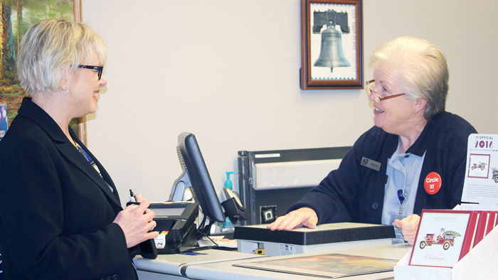 Retail and Customer Service Operations VP Kelly Sigmon visits Retail Associate Janice Strickland at the Cumming, GA, Post Office. Cumming was one of several locations Sigmon visited recently, along with the top-ranked Hazelhurst, Vidalia and Toccoa offices.