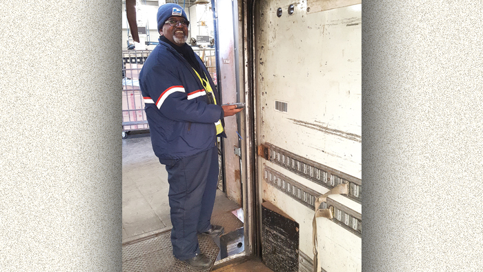 Postal Vehicle Service Driver Gerald Jacob scans a trailer label recently at the Merrifield, VA, Processing and Distribution Center.