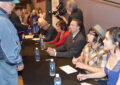 Customers line up after the ceremony to have their programs autographed by Graves and other participants.