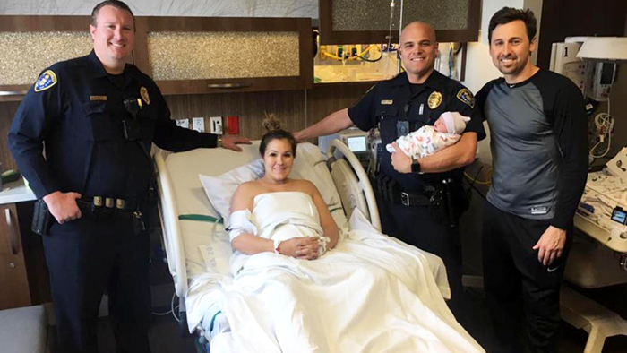 San Diego police officers Matt Enderlin and Eric Hustad, holding baby Pierce