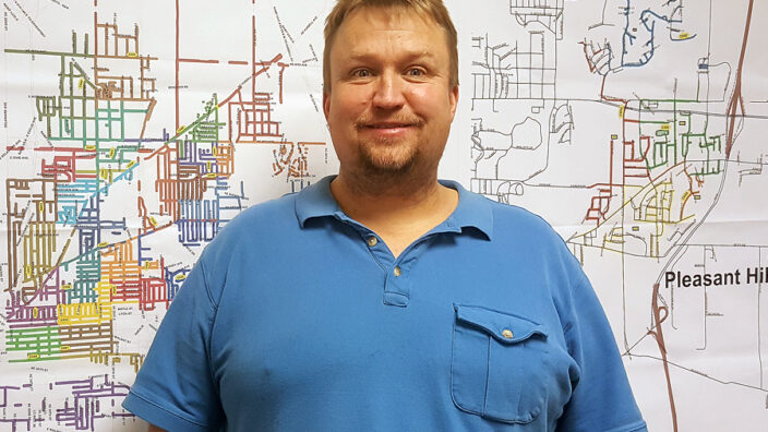 Man poses in blue shirt