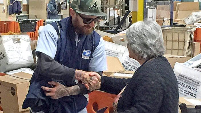 USPS employee shakes hands with supervisor