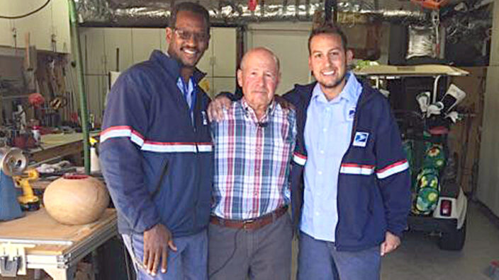 USPS employees flank customer