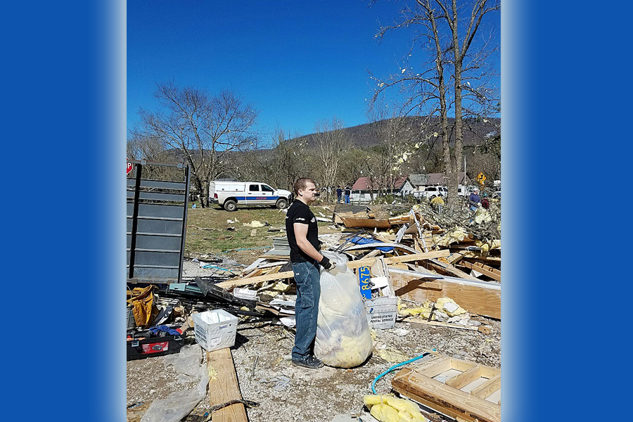 Employee cleans up tornado destruction