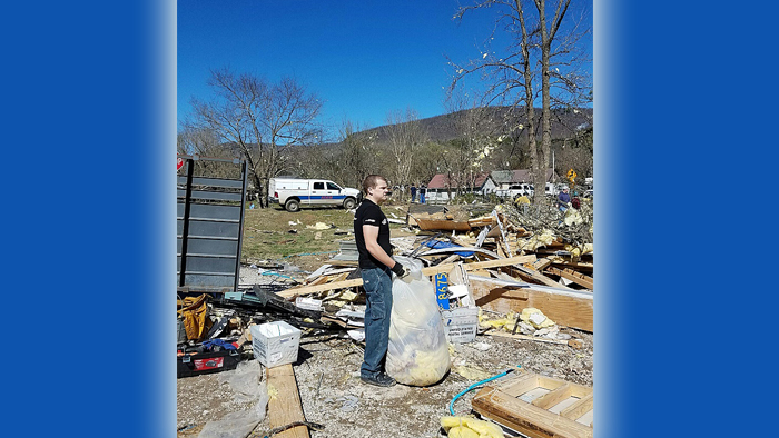 Employee cleans up tornado destruction