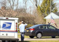 USPS employee salutes U.S. flag