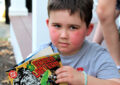 Devin reads a comic book collection donated by one of the postal employees.