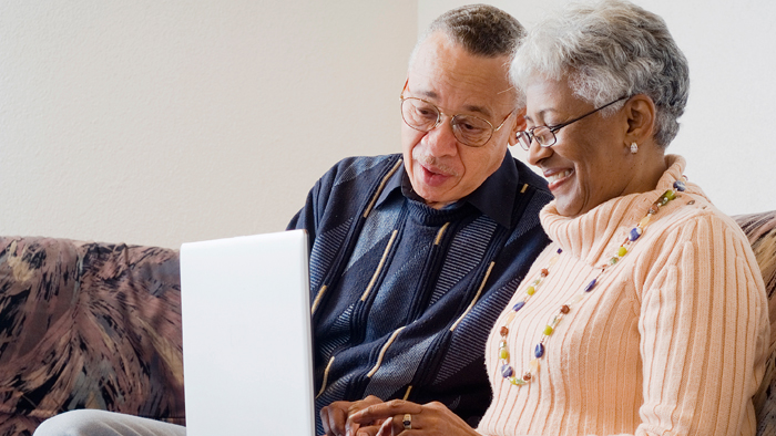 Senior couple using laptop