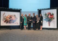 Participants gather on stage after the stamps are unveiled. From left are James Miller, a Missouri Botanical Garden senior vice president; USPS art director Ethel Kessler; Peter Wyse Jackson, president of the botanical garden; Chief Postal Inspector Guy Cottrell; Caggiano; and St. Louis Postmaster Cathy Vaughn.