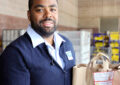 Male carrier poses with bagged goods