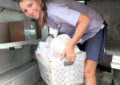 Female carrier holds boxed goods