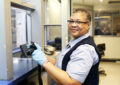 USPS employee holding camera