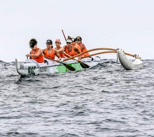 Canoe racers in water