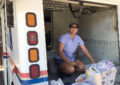 USPS employee loading food drive donations on vehicle