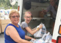 USPS employee and child holding food drive donations