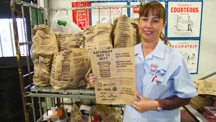 Woman holds Stamp Out Hunger bags