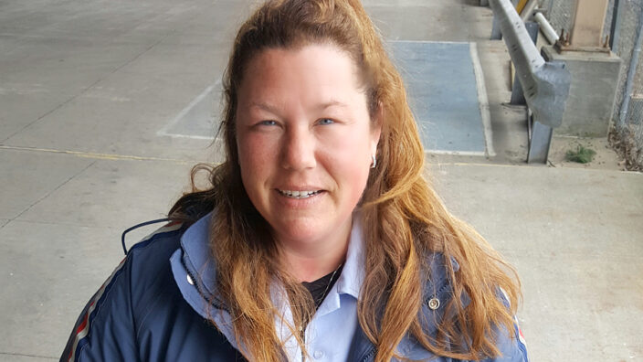 Woman in uniform smiles for camera