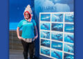 USPS employee stands near Sharks stamp display