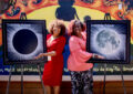 USPS employees display eclipse stamp artwork