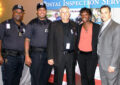 Postal Inspection Service employees stand near booth