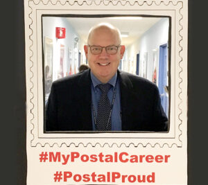 Schenectady, NY, Postmaster John Reilly poses for picture