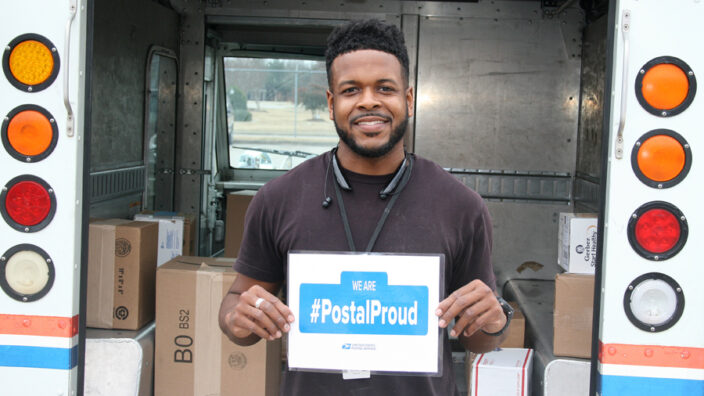 USPS employee standing in front of truck