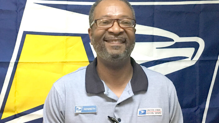 Man in glasses in retail uniform