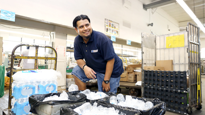 Employee stocking water bottles