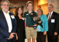 People pose with eagle