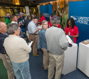 Customers line up at USPS stamp booth