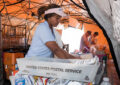 Woman sorts mail in tent