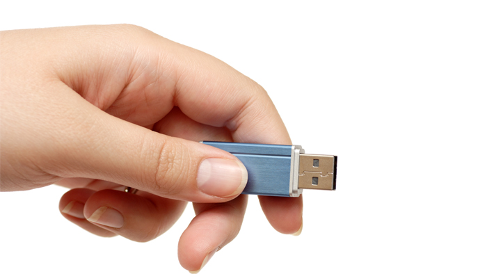 Hand holding a thumb drive