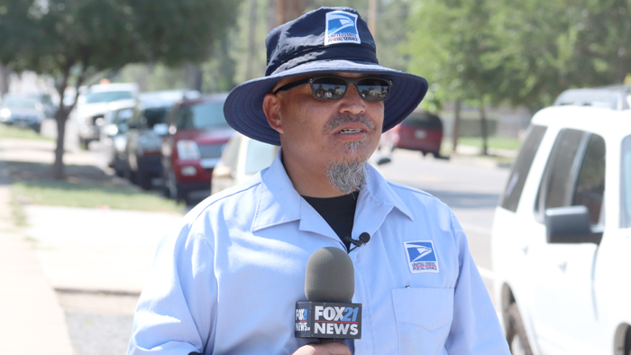Male letter carrier with hat interviewed