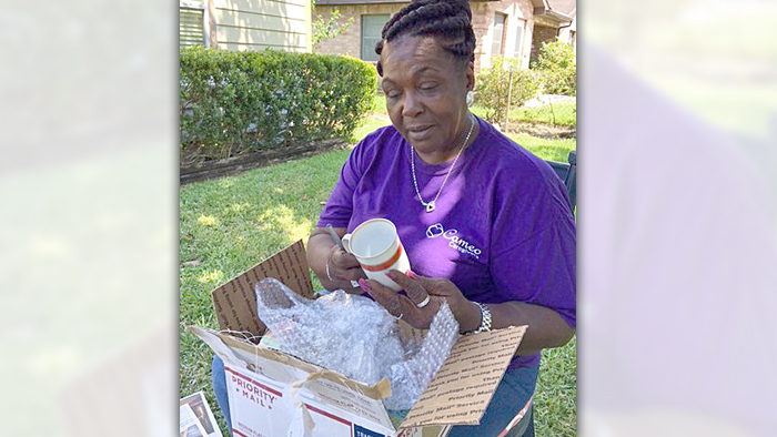 Customer Shirley Hines opens a Priority box