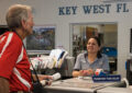 USPS employee talks to customer at Post Office counter