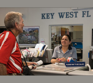 USPS employee talks to customer at Post Office counter