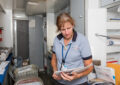 Woman sorts mail in mobile unit