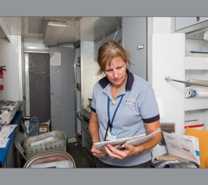 Woman sorts mail in mobile unit
