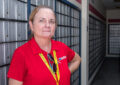 Woman stands in Post Office lobby