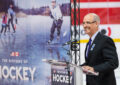 TV weatherman Paul Gross smiles at podium