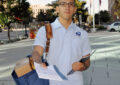 Male letter carrier on sidewalk