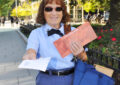 Female letter carrier on sidewalk