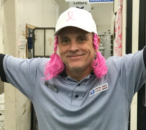 Man wears pink pigtails