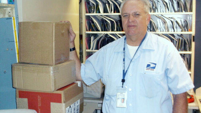 Man in uniform stands with packages