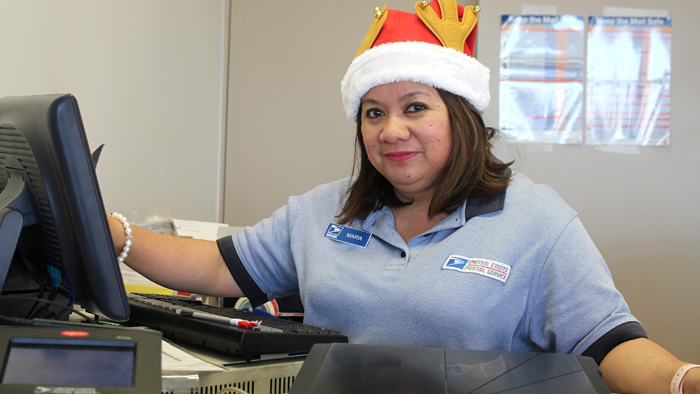 Retail associate wearing holiday hat