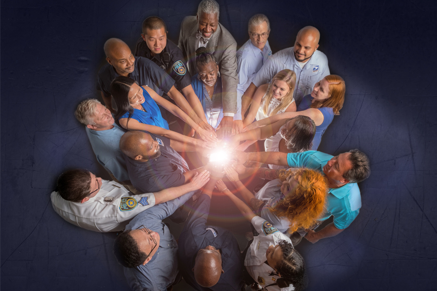 Circle of people with hands in center