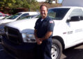 Man stands next to postal vehicle