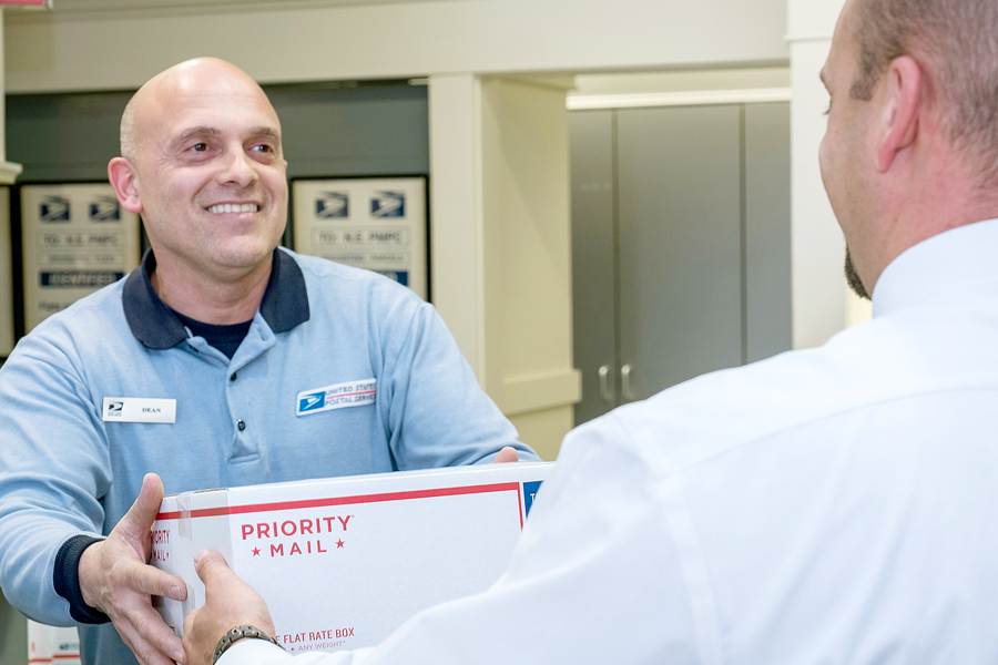 USPS retail worker receives package from customer