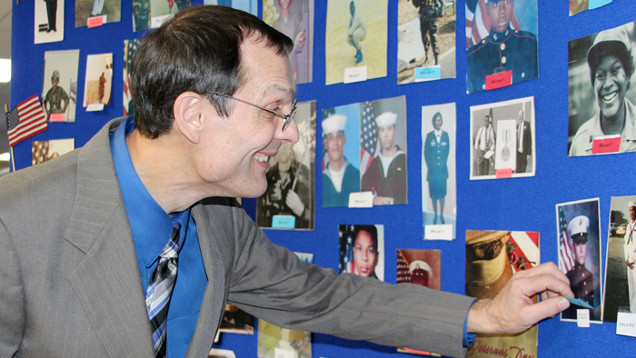 Employee looks at veterans display